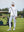 The model is wearing Women's Water-Resistant Stretch Fleece Lined Jacket white on the golf course.