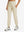 Model wearing women's stretch fleece lined water resistant joggers in light khaki, showcasing the front lower body view.