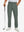 Lightweight moisture wicking dress pants in slate green, front lower-body with model leaning on golf club.