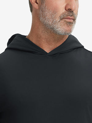Close-up from nose to chest, showing soft collar texture and stitching detail of the black hoodie.