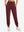 Model wearing women's stretch fleece lined water resistant joggers in wine, showcasing the front lower body view.