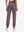 Model wearing women's stretch fleece lined water resistant joggers in light pinkish purple, showing the back lower body view.