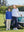 Mother and child leaning together by golf cart on course, both in youth long sleeve hoodied with kangaroo pocket in klein blue