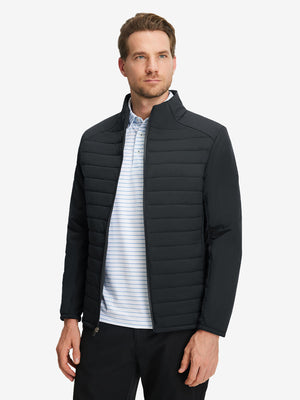Front upper body shot of model wearing black warm puffer winter golf jackets