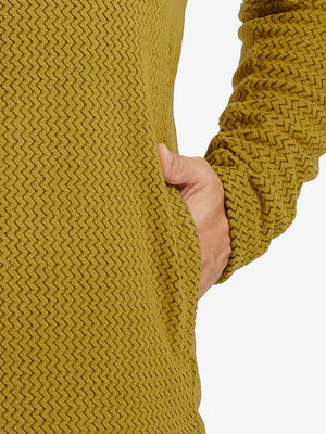 Close-up of pocket detail on midweight warm stretchy quarter zip pullover in yellow, showing neat stitching.