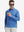 Front upper body view of model standing, holding coffee cup, wearing lightweight print long sleeve polo in line animal.