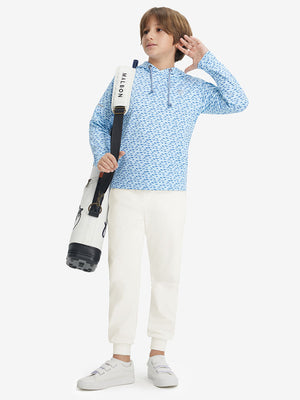 Full-body shot of model wearing beige fleece stretch water resistant boys joggers with a golf bag on her back.
