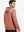 Back upper body view of the brick melange classic heather hoodie, model turns head slightly with ease.