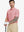 Half-body front view of model holding golf club wearing PINK HEATHER Premium Stretch Heather Polo.
