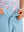 Detail: waistband of sky blue boys lightweight dry fit flat front golf shorts