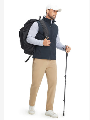Full-body shot of model while wearing sleeveless softshell fleece outdoor vests with 6 pockets in navy