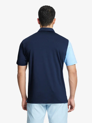 Back half-body view of model in NAVY Moisture Wicking Color Block Polo Shirt.