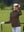 The model is wearing Women's Water-Resistant Stretch Fleece Lined Jacket brown on the golf course.