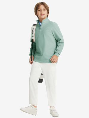 Full body model carrying a golf bag, wearing youth winter micro-fleece quarter zip pullover in dusty green