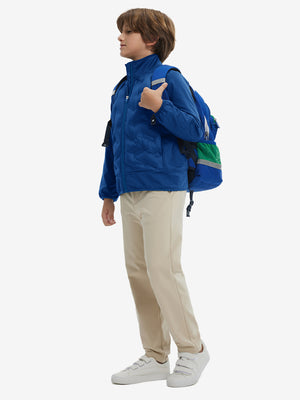 Model carrying a golf bag, wearing boys windproof puffer jacket with pockets, shown in klein blue.