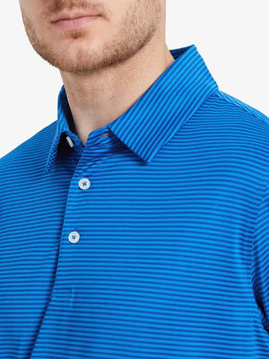 Front view from nose to chest: model in COBALT STRIPE polo, bold stripes for a confident golf look