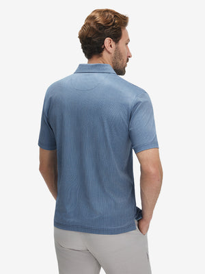 Back upper body view of model in Performance quick dry print golf polos with subtle navy light blue ovals tone