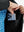 Close detail of hands inside pockets of boys windproof puffer jacket with pockets in black.