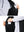 Close-up detail showing phone in the pocket of sleeveless softshell fleece outdoor vests with 6 pockets in black