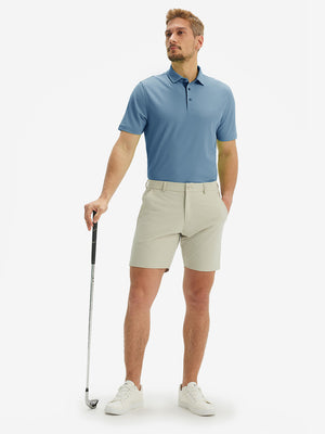 Full-body front view of model with a golf club wearing the misty blue ventilated pique performance polo on the course