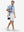 Full-body shot of model carring a golf bag in sky blue flower performance quick dry print golf polos