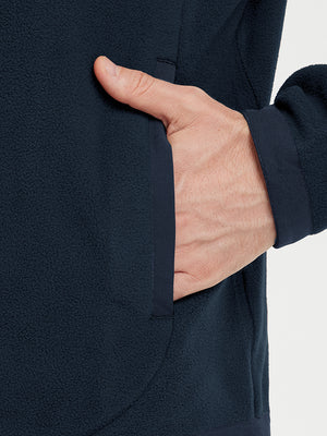 Hand in pocket detail of the Navy Quarter Zip Polar Fleece Sweatshirt, soft fleece fabric.