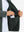 Close-up of winter thermal outdoor water resistant fleece jacket pocket holding a phone, practical detail in grey