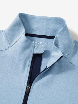 Close-up collar detail of light blue two tone pique cotton blend q-zip with subtle logo