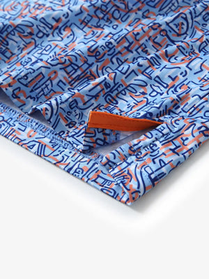 Detail view of the blue doodles pattern polo, highlighting the neat hem opening and fine stitching for comfort.