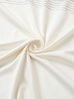 Close-up of cream premium performance polo fabric showing smooth texture.