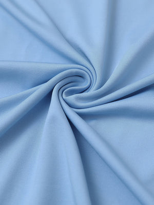 Close-up of fabric on everyday jersey henley shirt, soft knit texture with relaxed light blue tone