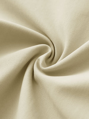 Close-up of light khaki stretch plain everyday pants fabric showing smooth texture and flexible weave.