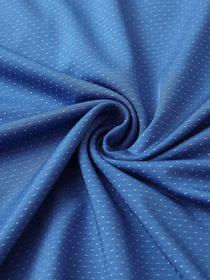 Close-up of blue 4 way stretch jacquard polo fabric texture highlighting intricate woven pattern and elasticity.
