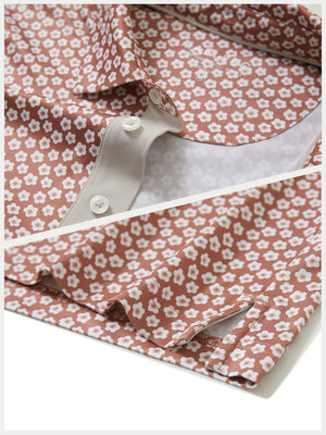 Detail shot of collar and hem of brick white flower performance quick dry print golf polos
