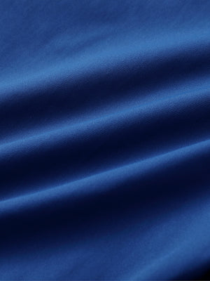 Close-up of cobalt water resistant everyday pants fabric showing durable texture and protective finish.
