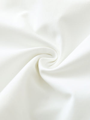 Close-up fabric detail of 4-way stretch performance solid shorts, smooth texture with flexible white feel