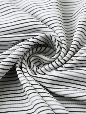 Close-up fabric detail of performance stripe golf shirts, breathable texture with soft dark grey neutral grey finish