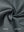 Close-up of the inside-out fabric of the reversible fleece jacket with 5 pockets in dark grey.