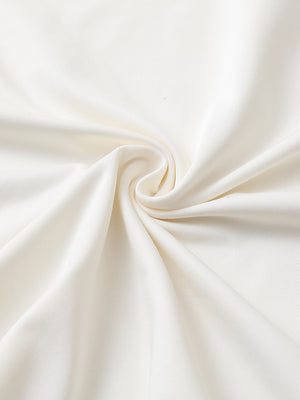 Close-up of cream chest print polo shirt fabric showing smooth texture and crisp graphic application area.