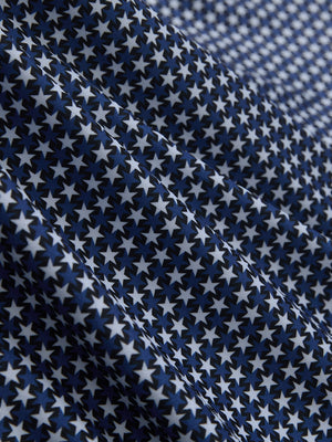 Fabric close-up of Performance quick dry print golf polos showing breathable texture in blue white stars