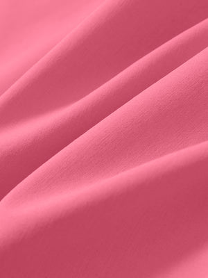 Macro view of the peach pink stretch soft flat front dress golf shorts fabric, showcasing the smooth texture