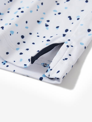 Close-up of the hem vent on the blue navy dot 4 way stretch print collared polo shirt, showing the side split for movement
