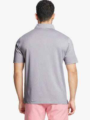 Rear half-body view showing fit and jacquard pattern of Ventilated Heather Jacquard Polo – FADED DENIM HEATHER