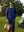 Model in cobalt heather fleece hoodies pullover holding a bag on the golf course