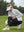 Woman adjusting ankle zip on Women's Ultra-stretch Quick Dry Sweatpants with Ankle Zips in black on golf course