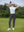 Woman wearing Women's Ultra-stretch Quick Dry Sweatpants with Ankle Zips in dark grey, holding golf club on course