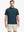 Half-body front view holding a golf club, wearing the BLUE INDIGO polo on the course.