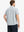 Half-body back view displaying the clean lines of the GLACIER GREY polo.