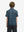 Back half-body view of youth wearing navy ocean beach performance print boys golf polo, showing rear design
