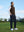 Model holding a golf club on the course, print collar quarter zip golf vest in coffee brown with sporty look